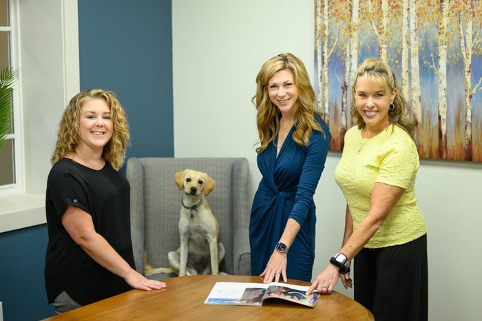 Attorney Sitterley with office staff and her dog Honey